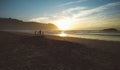 Silhouettes of children playing in the beach at sunset