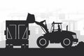 Silhouettes of heavy machinery with the operator driving a front loader and filling a truck with materials over a city under