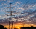 Silhouettes high voltage electric pylon in sunset background Royalty Free Stock Photo