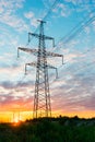 Silhouettes high voltage electric pylon in sunset background Royalty Free Stock Photo