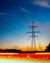 Silhouettes high voltage electric pylon in sunset background Royalty Free Stock Photo