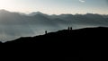 Silhouettes of hikers against mountains