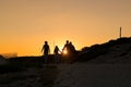 Silhouettes of hikers enjoying sunset.