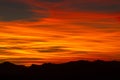 Silhouettes of hills under a cloudy sky during a beautiful sunset in Patagonia, Argentina Royalty Free Stock Photo