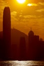 Silhouettes of Hong Kong skyscrapers against golden sky