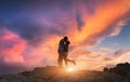 Silhouettes of a hugging and kissing man and girlfriend