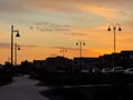 Silhouettes of lampposts on the street at golden sunset Royalty Free Stock Photo