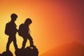 Silhouettes of little boy and girl hiking at sunset Royalty Free Stock Photo