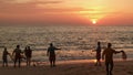 Silhouettes of local indian fishermen catching fish by fish net in Indian ocean with stunning sunset on background. Royalty Free Stock Photo