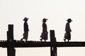 Silhouettes of local women in hats walking on u bien bridge Mandalay, Myanmar