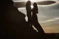 Silhouettes of love couple man and woman at rock mountain in beautiful nature sunset. Couple love concept. Shadow Royalty Free Stock Photo