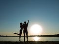 Silhouettes of a loving couple on the beach. Sunset on the beach