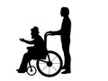 Silhouettes of man walking his grandfather in wheelchair Royalty Free Stock Photo