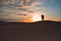 Silhouettes of a man and a woman on top of a sand dune in the Sahara desert Royalty Free Stock Photo