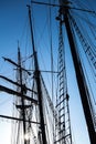 Silhouettes of the masts and rigging of a sailing ship
