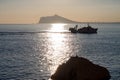 Silhouettes in the Mediterranean of a fishing boat and the Sierra Helada of Benidorm Royalty Free Stock Photo