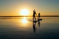 Silhouettes of men, friends paddling on a SUP boards Royalty Free Stock Photo