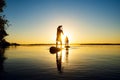 Silhouettes men, friends who are paddling on a SUP boards