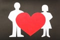 Silhouettes of men, women and heart cut out of pape. Royalty Free Stock Photo