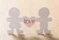 Silhouettes of men, women and heart cut out of paper Royalty Free Stock Photo