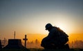 silhouettes military man kneeling of grave fallen soldier in a graveyard. Concept veteran of war veterans day, memorial day