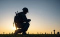 silhouettes military man kneeling of grave fallen soldier in a graveyard. Concept veteran of war veterans day, memorial day