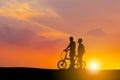 Silhouettes of mother and son playing at sunset evening sky background Royalty Free Stock Photo