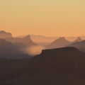 Silhouettes of Mount Wiriehore and other mountains in the Bernese Oberland. Golden sunset in the Swiss Alps.