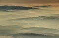 Silhouettes of mountain ridges in sea of fog at sunrise Poland Royalty Free Stock Photo