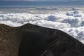 Silhouettes of mountaineers over clouds at the edge of an extinct crater at volcano Etna Royalty Free Stock Photo