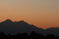 Silhouettes of mountains with an orange color of sunset and sunrise. Forest silhouettes