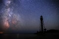 Silhouettes of the Old Lighthouse sandy beach and ocean against the background of the starry sky Royalty Free Stock Photo