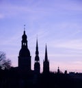 The silhouettes of old riga towers against morning sky