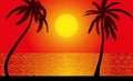 Silhouettes of palm trees against the backdrop of the setting sun over the sea Royalty Free Stock Photo