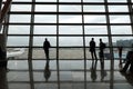 Passengers waiting for departure in Moscow International Airport Vnukovo, view from big panoramic window to the aero field Royalty Free Stock Photo