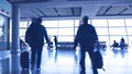 Silhouettes of passengers walking in an airport Royalty Free Stock Photo