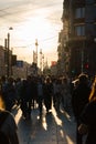 Silhouettes of passers-by walking along the street