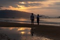 Silhouettes of people on the background of a dawn on the beach of Sanya, Hainan Island, China