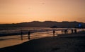 Silhouettes of people on the beach at sunset Royalty Free Stock Photo