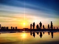 The Silhouettes People on the Beach at Sunset Royalty Free Stock Photo