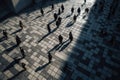 Silhouettes of people with dark shadows standing on street in city center