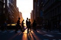 Silhouettes of people crossing a busy intersection on 5th Avenue in New York City with sunset in the background Royalty Free Stock Photo