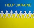 Silhouettes of people cut out of paper hold hands Ukrainian flag Royalty Free Stock Photo