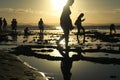 Silhouettes of people enjoying photographing sunset time by low tide at Ponta do Muta beach in Barra Grande, Brazil, South America