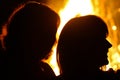 Silhouettes of people on a fire background