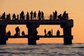 Silhouettes of the people fishing and enjoying the sunset Royalty Free Stock Photo