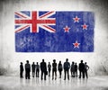 Silhouettes of People and Flag of New Zealand Royalty Free Stock Photo