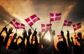 Silhouettes of People Holding the Flag of Denmark Royalty Free Stock Photo