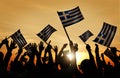 Silhouettes of People Holding Flag of Greece