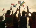 Silhouettes of people holding flags from various countries. Royalty Free Stock Photo